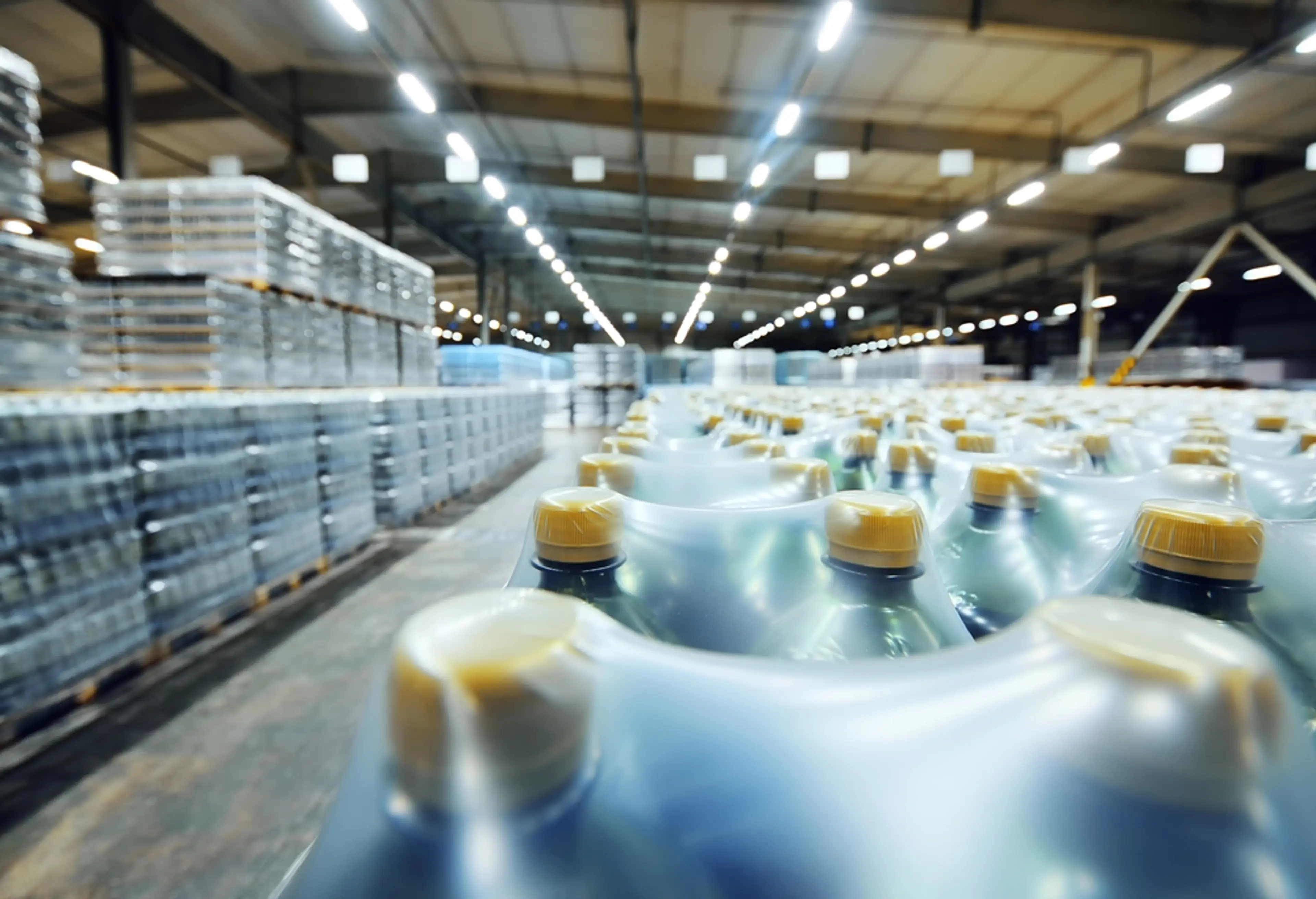 Shrink wrapped plastic bottles on pallets in warehouse