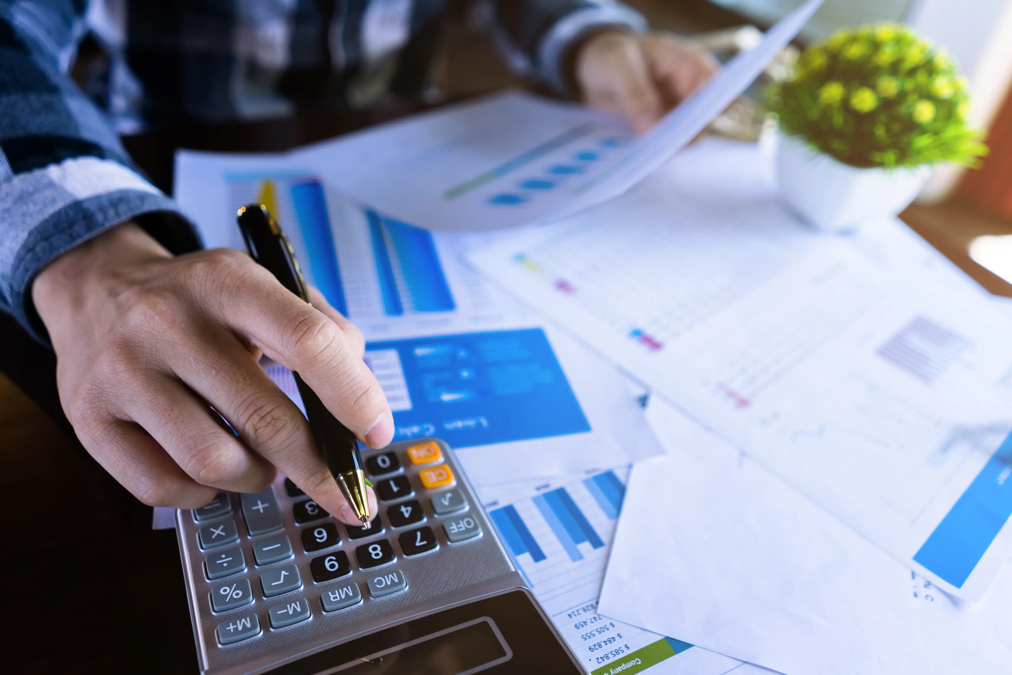 Man with calculator and report