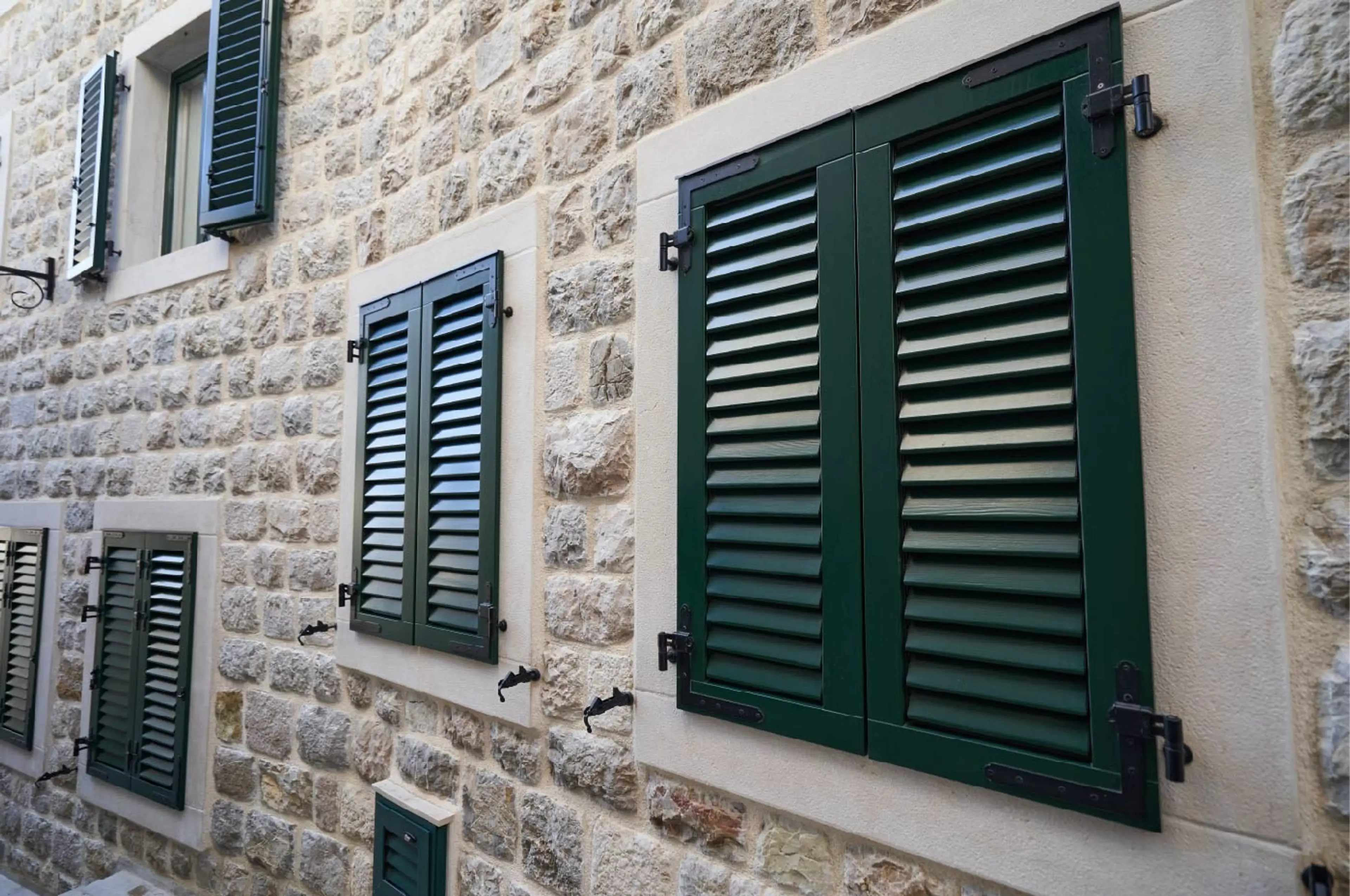 green-plastic-shutters-on-windows